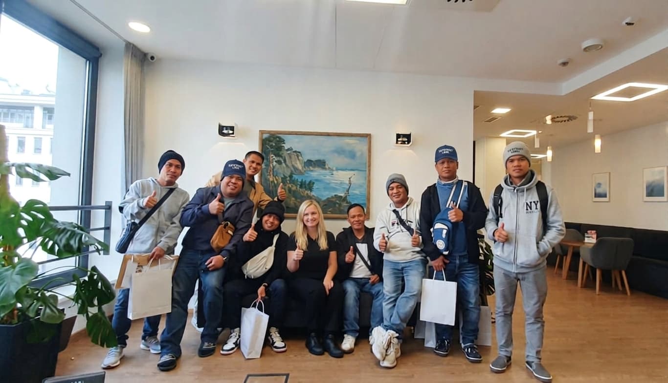 SafeTrust-deployed Filipino workers with a SafeTrust team member